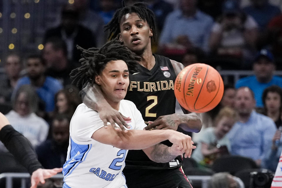 North Carolina guard Elliot Cadeau (2) passes the ball as Florida State forward Jamir Watkins (2) defends during the second half of an NCAA college basketball game in the quarterfinal round of the Atlantic Coast Conference tournament, Thursday, March 14, 2024, in Washington. (AP Photo/Susan Walsh)