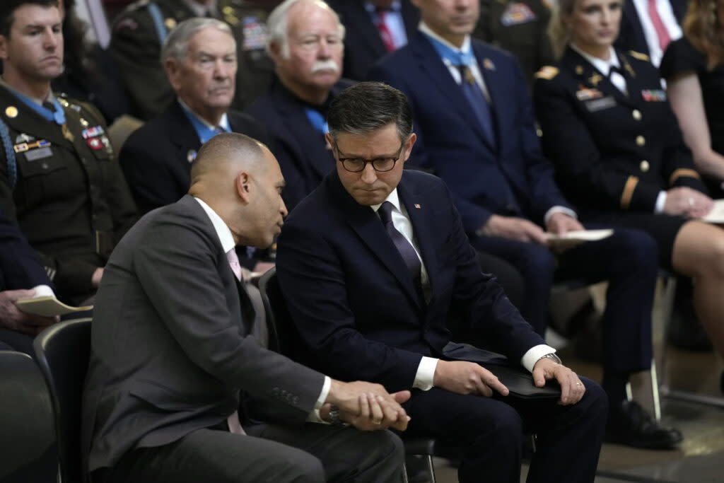 House Minority Leader Hakeem Jeffries, D-N.Y., left, and House Speaker Mike Johnson, R-La., talk during a ceremony as the remains of retired Army Col. Ralph Puckett lie in honor during his congressional tribute in the Rotunda of the U.S. Capitol on April 29, 2024, in Washington, D.C.