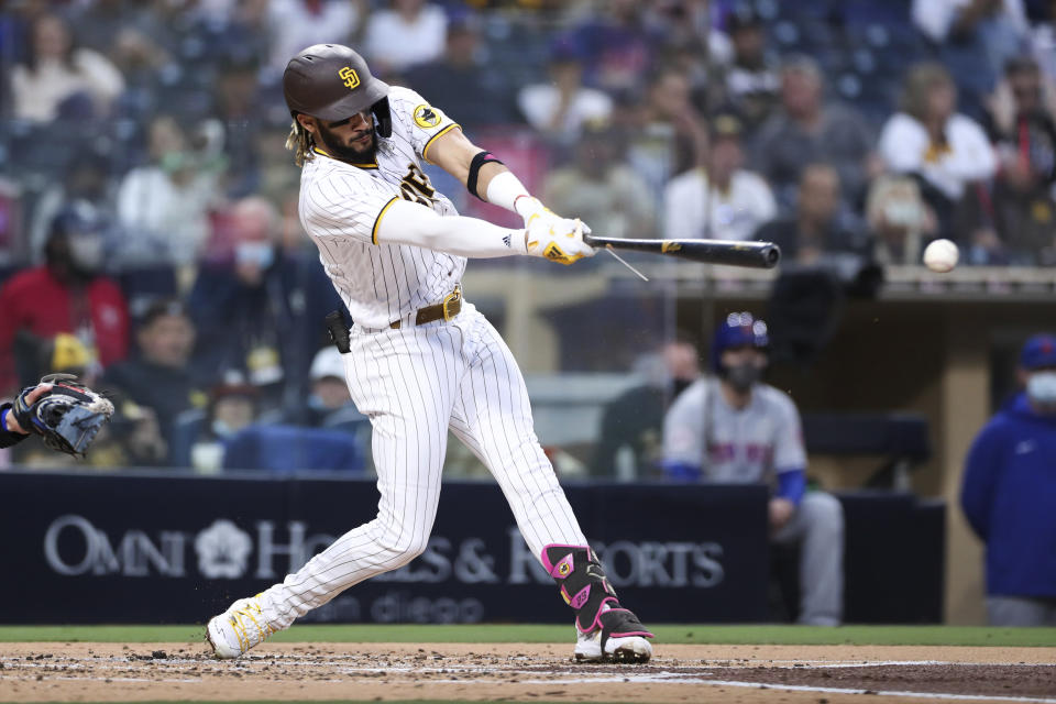 San Diego Padres' Fernando Tatis Jr. hits a double in the second inning of the team's baseball game against the New York Mets on Saturday, June 5, 2021, in San Diego. (AP Photo/Derrick Tuskan)