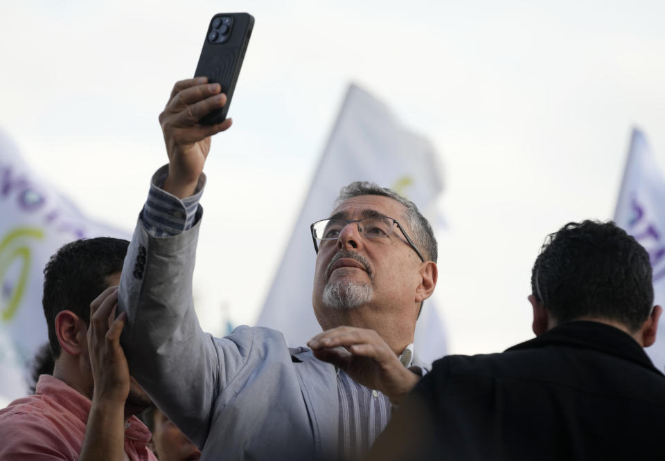 Guatemalan presidential candidate Bernardo Arevalo of the Semilla party takes a selfie with his supporters at Constitution Square in Guatemala City, Monday, June 26, 2023. Arevalo and former first lady Sandra Torres of the UNE party are going to an Aug. 20 presidential runoff. (AP Photo/Moises Castillo)