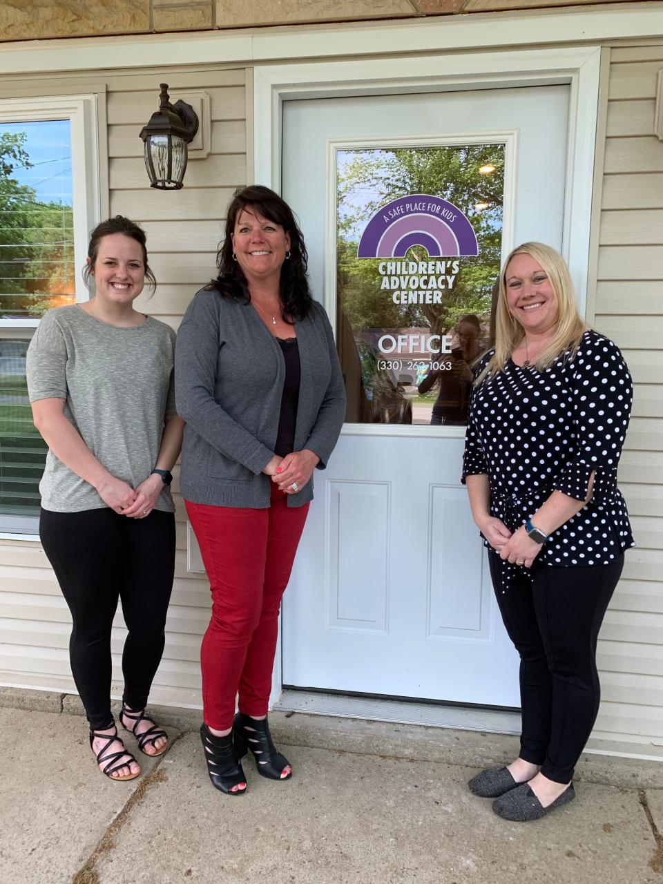 Wayne County Children's Advocacy Center staff members, case manager and victim's advocate McKenna Bowman; executive director Lara Kiefer; and forensic interviewer Michelle Budzinski, stand outside the entrance to their offices in this 2021 photo.