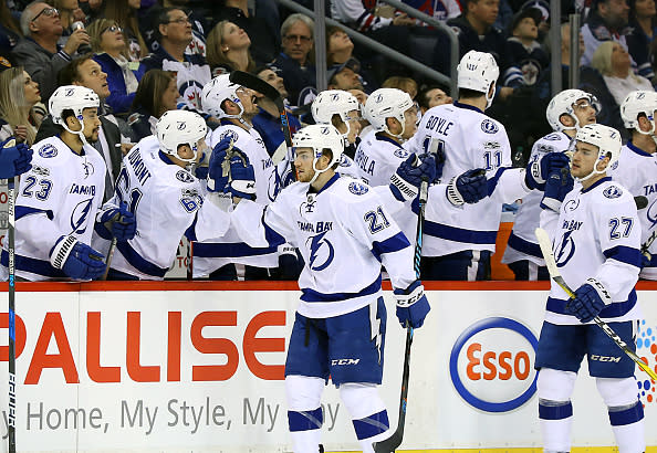 WINNIPEG, MB - FEBRUARY 11: Brayden Point #21 of the Tampa Bay Lightning celebrates his first period goal against the Winnipeg Jets with teammates at the bench at the MTS Centre on February 11, 2017 in Winnipeg, Manitoba, Canada. (Photo by Darcy Finley/NHLI via Getty Images)