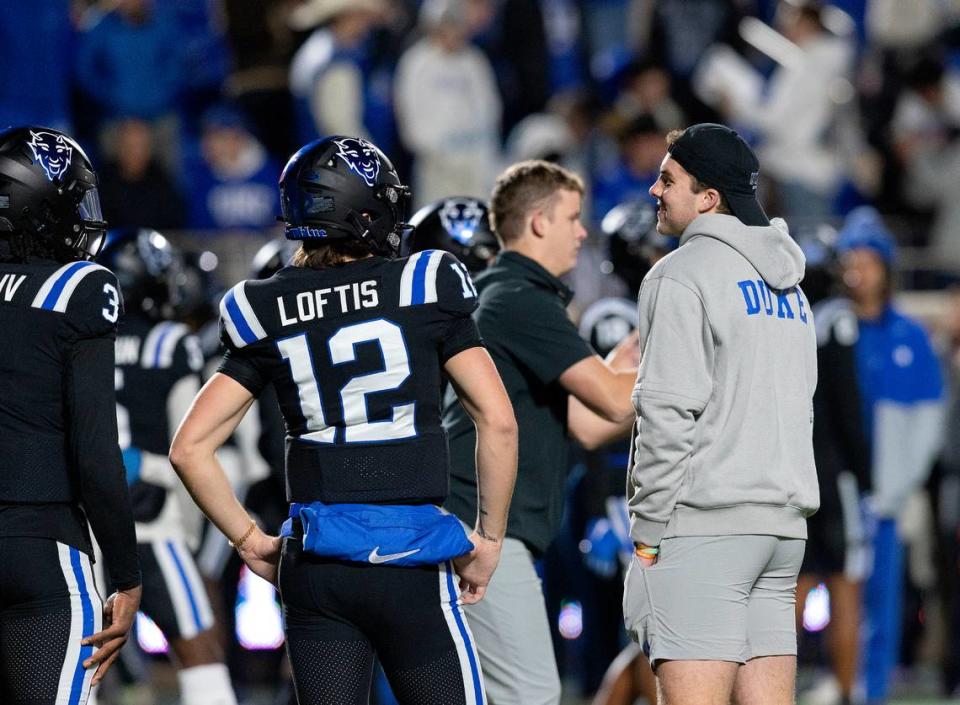 Duke quarterbacks Grayson Loftis and Riley Leonard stand on the field during warm-ups prior to the Blue Devils’ game against Wake Forest on Thursday, Nov. 2, 2023, at Wallace Wade Stadium in Durham, N.C.