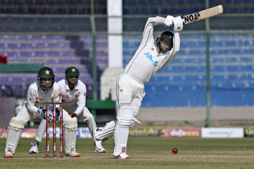 New Zealand's Devon Conway, right, plays a shot as Pakistan's Sarfraz Ahmed, left, and Babar Azam watch during the first day of the second test cricket match between Pakistan and New Zealand, in Karachi, Pakistan, Monday, Jan. 2, 2023. (AP Photo/Fareed Khan)