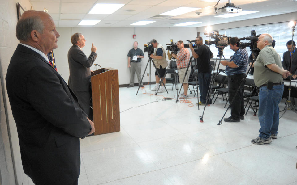 Alamance County Sheriff Terry S. Johnson stands to the side as his attorney, Chuck Kitchens, speaks to reporters Tuesday, Sept. 18, 2012, in Graham, N.C. A two-year investigation by the U.S. Department of Justice has found that Johnson and his deputies routinely discriminated against Latinos by making unwarranted arrests with the intent of maximizing deportations. In a report issued Tuesday, the federal agency said Johnson and his deputies violated the constitutional rights of U.S. citizens and legal residents by illegally targeting, stopping, detaining and arresting Latinos without probable cause. Johnson told reporters at a news conference that the report's findings are baseless and that "the Obama administration has decided to wage war on local law enforcement." (AP Photo/Burlington Times-News, Scott Muthersbaugh)