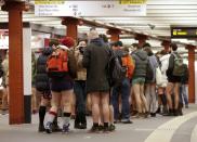 Passengers without their pants wait for a subway train during the "No Pants Subway Ride" event at Alexanderplatz subway station in Berlin January 12, 2014. The event is an annual flash mob and occurs in different cities around the world, according to its organisers. REUTERS/Fabrizio Bensch (GERMANY - Tags: SOCIETY ENTERTAINMENT)