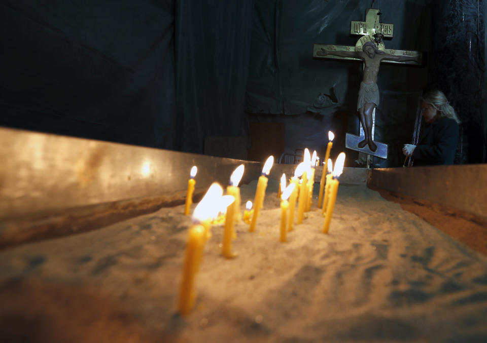 In this Thursday, April 16, 2020, a woman prays inside the St. Sava Temple during the coronavirus outbreak in Belgrade, Serbia. For Orthodox Christians, this is normally a time of reflection, communal mourning and joyful release, of centuries-old ceremonies steeped in symbolism and tradition. But this year, Easter - by far the most significant religious holiday for the world's roughly 300 million Orthodox - has essentially been cancelled. (AP Photo/Darko Vojinovic)