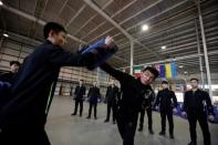 Trainees from Dewei Security attend boxing training at a training camp, on the outskirts of Beijing, China March 2, 2017. Picture taken March 2, 2017. To match Analysis CHINA-SILKROAD/SECURITY REUTERS/Jason Lee