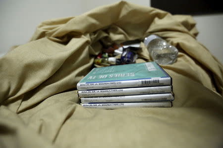 DVDs of a TV series are seen on the sheets of a bed inside a safe house, where five people were shot dead during an operation on Friday to recapture the drug lord Joaquin "El Chapo" Guzman, at Jiquilpan Boulevard in Los Mochis in Sinaloa state, Mexico, January 11, 2016. REUTERS/Edgard Garrido