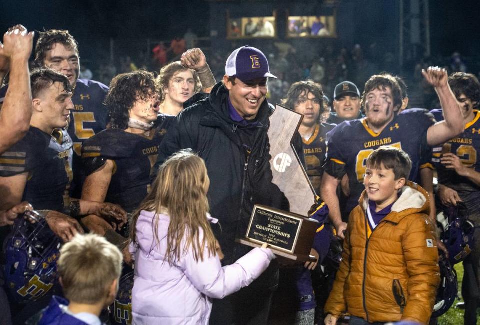 Escalon head coach Andrew Beam and his team celebrate their 28-7 victory over Northwood in the CIF State Division 4-AA Football Championship game in Escalon, Calif., Saturday, Dec. 10, 2022.