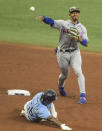 New York Mets shortstop Francisco Lindor, right, throws to first for a double play after forcing out Tampa Bay Rays' Randy Arozarena, left, at second base during the fifth inning of a baseball game Sunday, May 16, 2021, in St. Petersburg, Fla. (AP Photo/Steve Nesius)