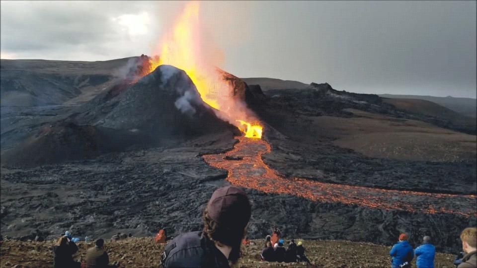 Rabbi Avraham Feldman waving in front of a volcano