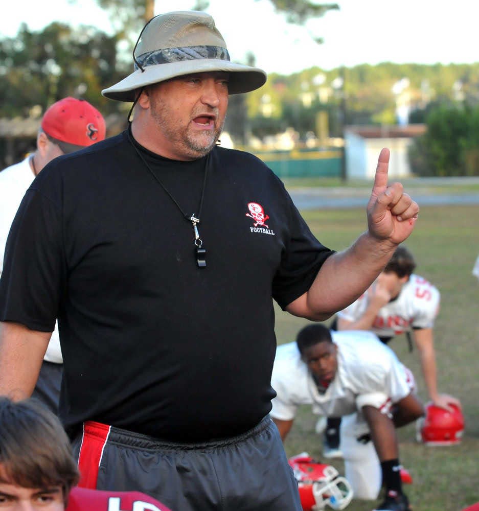 Coach Donald Chumley talks with the Savannah Christian team during practice.