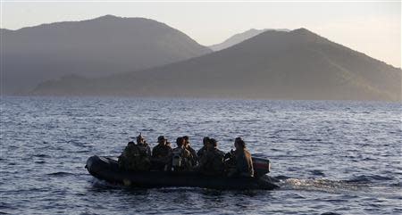 Members of the Philippine marines are transported on a rubber boat from a patrol ship, after a mission at the disputed Second Thomas Shoal, part of the Spratly Islands in the South China Sea, as they return to a naval forces camp in Palawan province, soutwest Philippines March 31, 2014. REUTERS/Erik De Castro