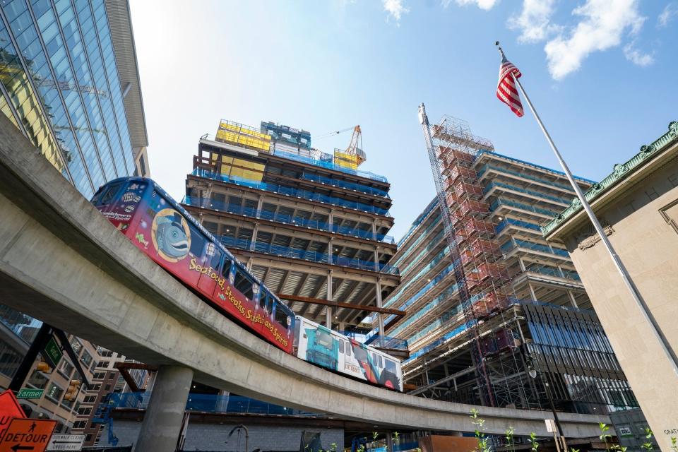 The People Mover cruises by as construction continues at the Hudson's site on Aug. 30, 2022.