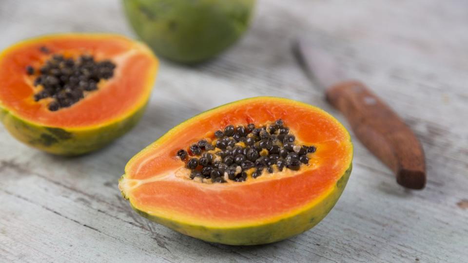 sliced papaya on wood