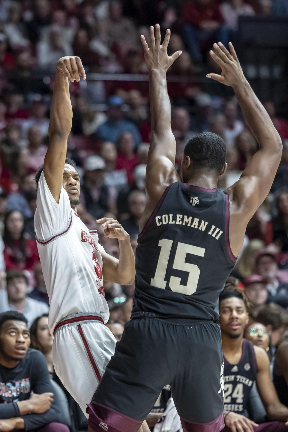 Alabama guard Rylan Griffen (3) shoots a three-point shot over Texas A&M forward Henry Coleman III (15) during the first half of an NCAA college basketball game, Saturday, Feb. 17, 2024, in Tuscaloosa, Ala. (AP Photo/Vasha Hunt)