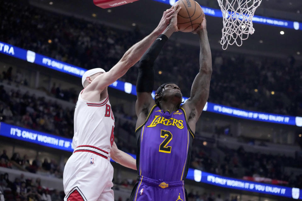 Los Angeles Lakers' Jarred Vanderbilt drives to the basket as Chicago Bulls' Alex Caruso defends during the first half of an NBA basketball game, Wednesday, March 29, 2023, in Chicago. (AP Photo/Charles Rex Arbogast)