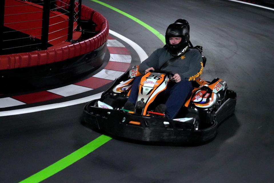 Patrick Kneeland keeps a tight line around a corner at R1 Indoor Karting. The entertainment complex in Lincoln has added a second level at the facility, where drivers who prove they're capable can race in karts that will go 45 mph.