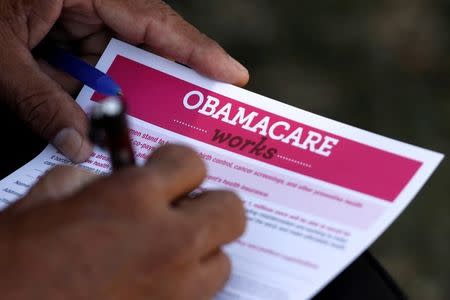 FILE PHOTO: A man fills out an information card during an Affordable Care Act outreach event hosted by Planned Parenthood for the Latino community in Los Angeles, California September 28, 2013. REUTERS/Jonathan Alcorn/File Photo
