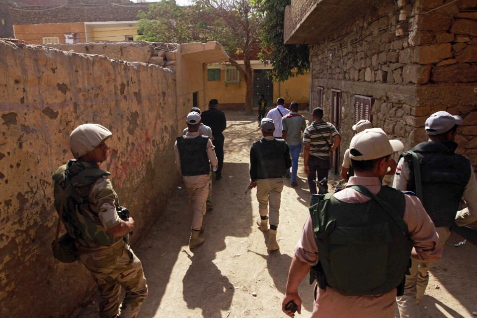 Egyptian security forces patrol as Egyptian prosecutor general, Hisham Barakat, tours the area where fighting took place on Friday, April 4, between a Nubian family and members of the Arab Haleyla clan, in the southern city of Aswan, Egypt, Tuesday, April 8, 2014. Telephone and Internet networks were briefly shut down to Egypt’s southern province of Aswan for several hours, as authorities moved to try to end a bloody tribal feud that killed tens the past week, security officials and residents said Tuesday. (AP Photo/Sabry Khaled, El Shorouk Newspaper) EGYPT OUT