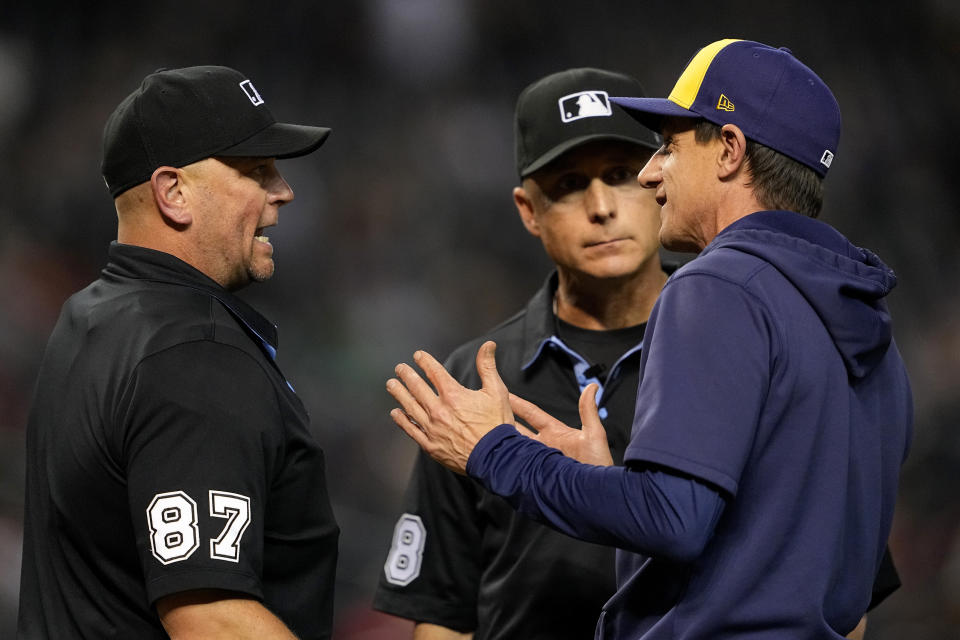 Milwaukee Brewers manager Craig Counsell, right, argues with home plate umpire Scot Barry, left, during the fourth inning of a baseball game against the Arizona Diamondbacks, Monday, April 10, 2023, in Phoenix. (AP Photo/Matt York)