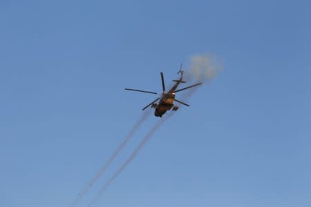 FILE PHOTO: A helicopter fires towards the Taliban during a fight between Taliban and Afghan security forces in Laghman province, Afghanistan March 1, 2017. REUTERS/Parwiz