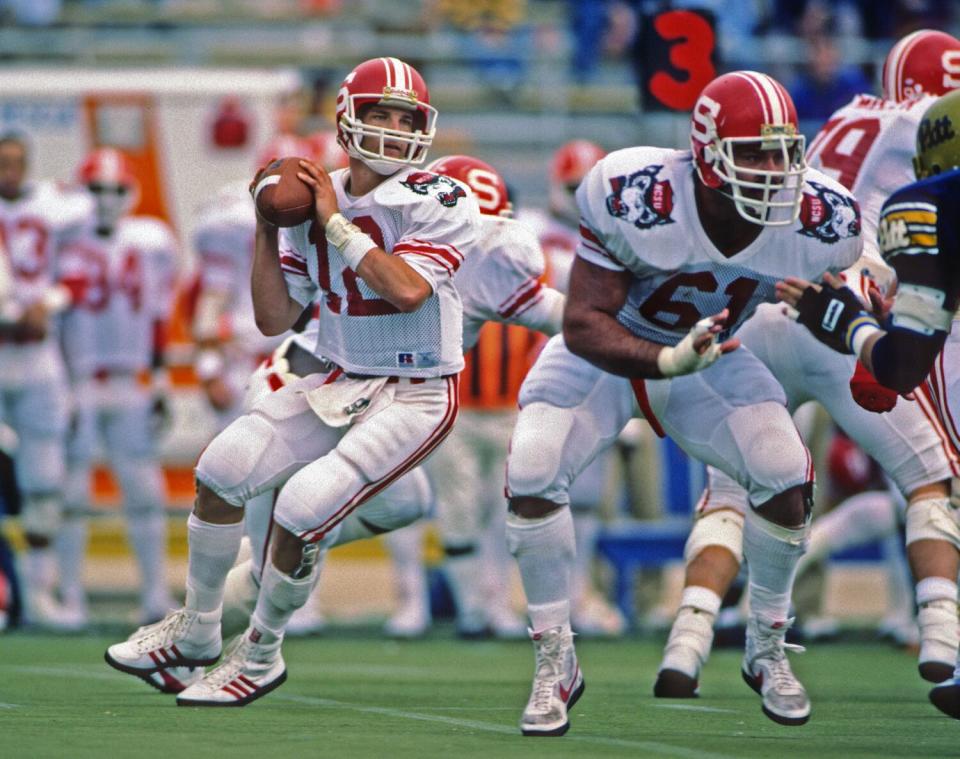 North Carolina State quarterback Erik Kramer looks to pass as offensive lineman Ron Kosor blocks.