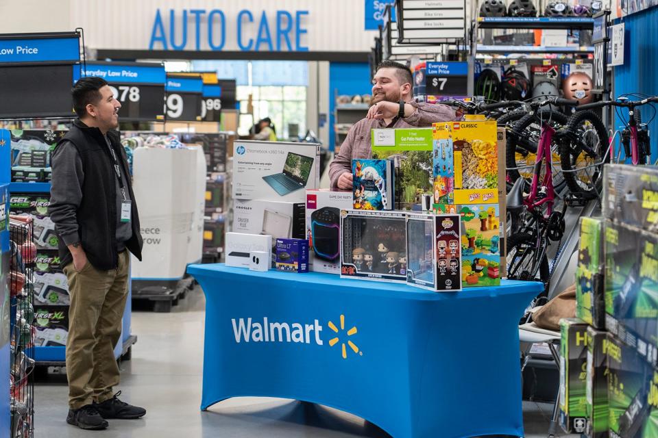 Giovanni Mata talks to Walmart representative Rowdy Riggins about early Black Friday deals at the Walmart on Whitestone Boulevard in Cedar Park on Nov. 16. Walmart began rolling out its Black Friday deals earlier than usual this year.