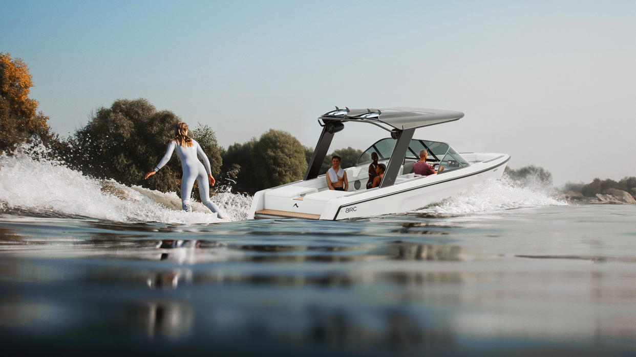  Arc Sport electric wake boat pulling waterskier. 