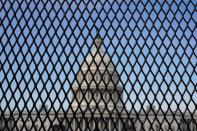 FILE PHOTO: The U.S. Capitol is seen through a security fence in Washington