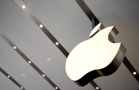 FILE PHOTO: The Apple logo is pictured inside the newly opened Omotesando Apple store at a shopping district in Tokyo June 26, 2014. REUTERS/Yuya Shino/File Photo