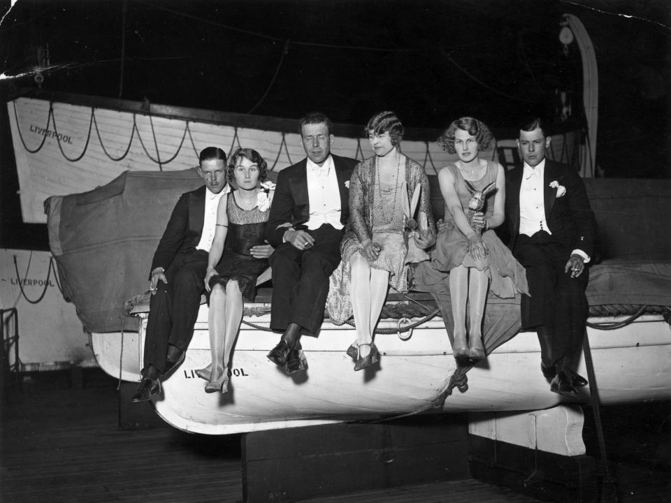 Guests sitting on a lifeboat during a dance aboard Berengaria in 1929.