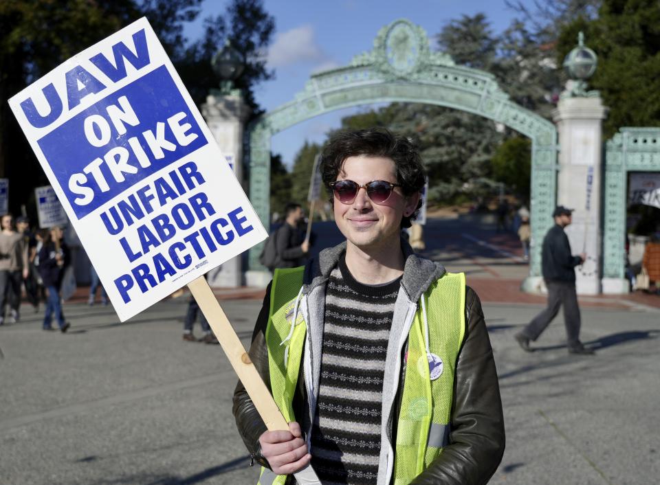 Jonathan Mackris, a doctorate student at the University of California, Berkeley, poses for a photo on campus in Berkeley, Wednesday, Dec. 7, 2022. Mackris is one of thousands of University of California academic workers on strike to demand higher wages and better benefits. A month into the nation's largest strike involving higher education, the work stoppage is causing stress for many students who are facing canceled classes, no one to answer their questions and uncertainty about how they will be graded as they wrap up the year. (AP Photo/Terry Chea)