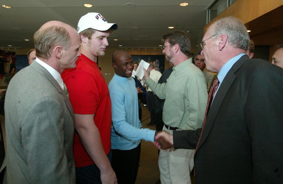 December 21, 2003: New UTEP head football coach Mike Price, right, shook hands with receiver Chris Marrow as defensive lineman Zach West, second from left, and Assistant Athletics Director for Football Operations Nate Poss, left, looked on Sunday at the Larry K. Durham Center.
