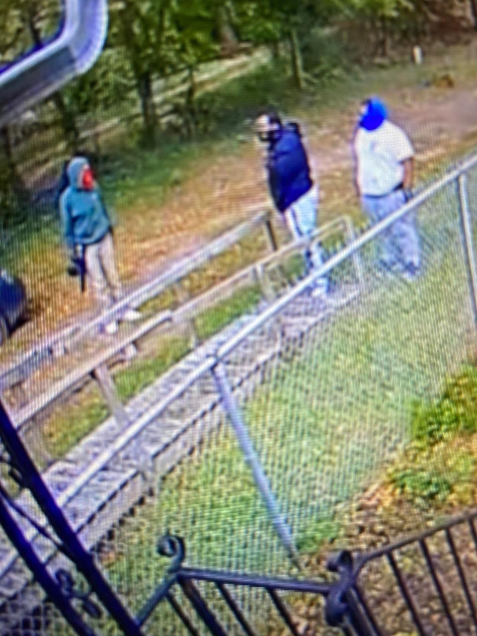 LMPD is searching for the two men on the right, wearing a blue hoodie and a white shirt, in connection to a 2020 homicide.