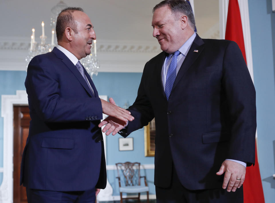 Secretary of State Mike Pompeo, right, and Turkish Foreign Minister Mevlut Cavusoglu, left, shake hands during their meeting at the State Department in Washington, Tuesday, Nov. 20, 2018. (AP Photo/Pablo Martinez Monsivais)