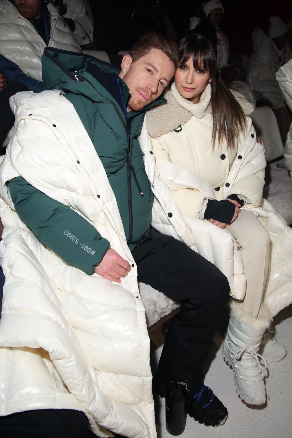 shaun white and nina dobrev sitting in the front row of moncler grenoble fall winter 2024