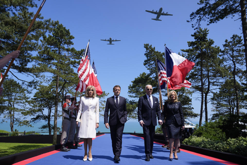 U.S. President Joe Biden, first lady Jill Biden, French President Emmanuel Macron, his wife Brigitte Macron, walk on stage during ceremonies to mark the 80th anniversary of D-Day, Thursday, June 6, 2024, in Normandy. (AP Photo/Evan Vucci)