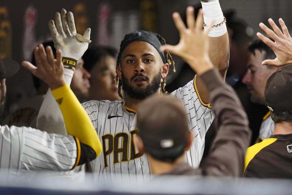 FILE - San Diego Padres' Fernando Tatis Jr. reacts with teammates after hitting a home run during the seventh inning of a baseball game against the Atlanta Braves, Sept. 24, 2021, in San Diego. Tatis Jr.'s surgically repaired left wrist hasn't progressed to the point where the electrifying All-Star shortstop can start swinging a bat, general manager A.J. Preller said Tuesday June 14, 2022. (AP Photo/Gregory Bull,File)