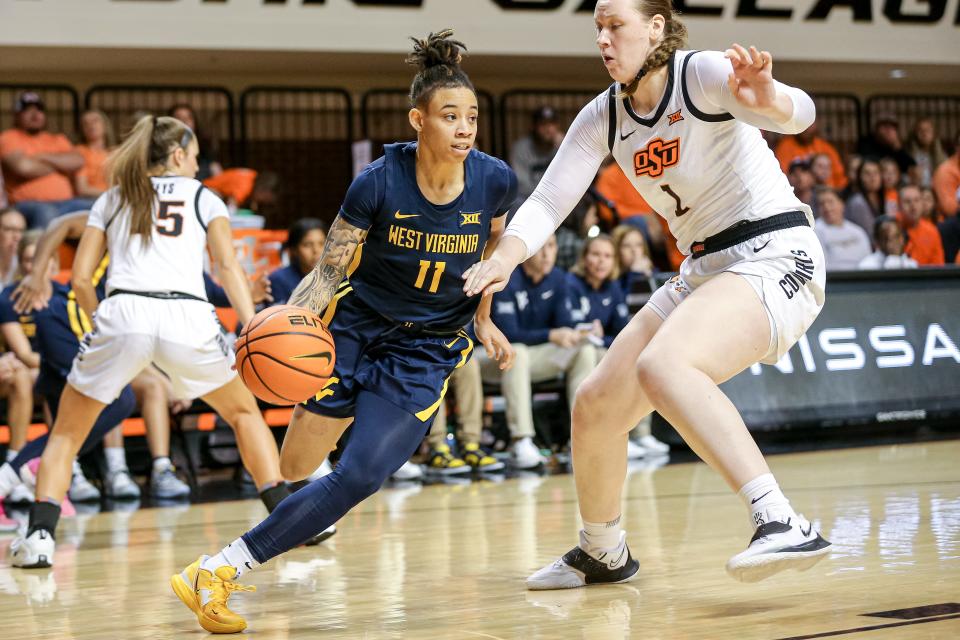 West Virginia guard JJ Quinerly, driving past Oklahoma State center Kassidy De Lapp last season, is the fifth-leading scorer in the Big 12 and will be a focal point for Texas on Saturday.