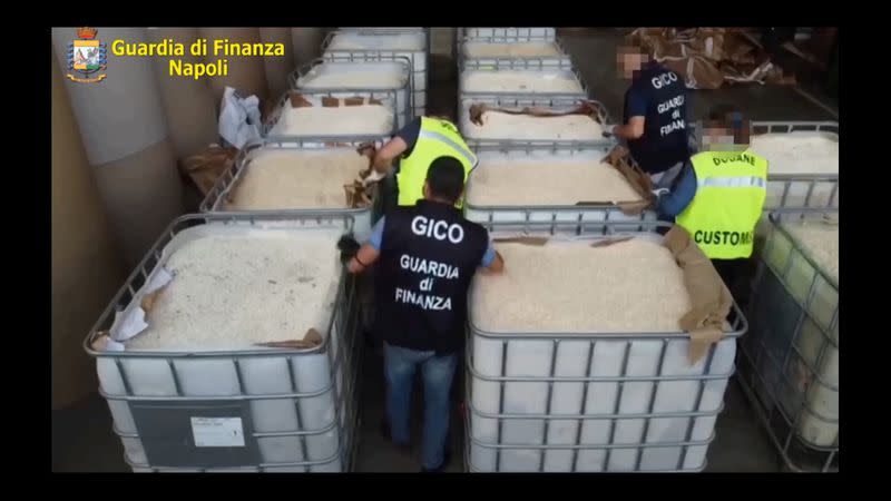 An undated handout image shows Italian finance police officers checking boxes that contain ISIS produced amphetamine pills in Salerno