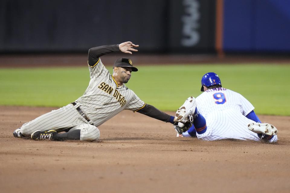 New York Mets' Brandon Nimmo (9) slides past San Diego Padres' Xander Bogaerts, left, to steal second base during the third inning of a baseball game Monday, April 10, 2023, in New York. (AP Photo/Frank Franklin II)