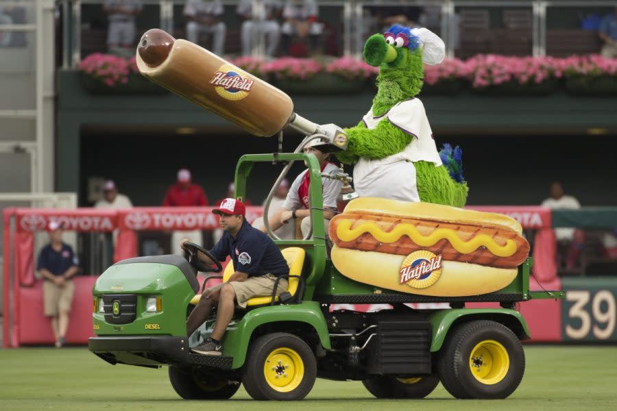 The Phillie Phanatic comes out with his Hot Dog Launcher during the fifth inning of a baseball game between the Atlanta Braves and the Philadelphia Phillies, Monday, July 4, 2016, in Philadelphia. For more than a quarter-century, Phillies fans thought dollar hot dog night was the best ballpark promotion — but the team has now decided it was the wurst. (AP Photo/Chris Szagola, File)