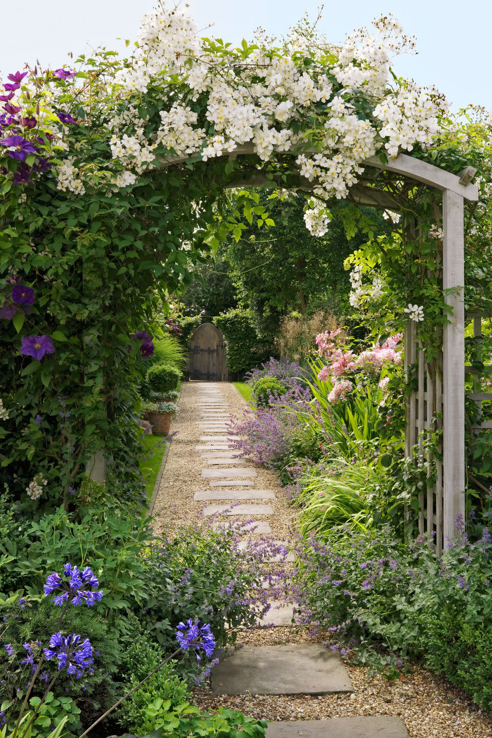 <p>Nestled behind hedges framing a cute wooden door, a cottage garden can be a lush oasis of fragrant blooms climbing over a garden trellises and pretty pathways.</p><p><strong><a href="https://www.countryliving.com/gardening/garden-ideas/g2340/cottage-garden-ideas/" rel="nofollow noopener" target="_blank" data-ylk="slk:Read more cottage garden ideas;elm:context_link;itc:0;sec:content-canvas" class="link ">Read more cottage garden ideas</a>.</strong></p><p><a class="link " href="https://go.redirectingat.com?id=74968X1596630&url=https%3A%2F%2Fwww.wayfair.com%2FOutsunny--Garden-Arch-Trellis-55.1-W-x-23.6-D-Wood-Arbor-845125-L7184-K%7EOTSU1351.html&sref=https%3A%2F%2Fwww.countryliving.com%2Fgardening%2Fgarden-tours%2Fg1432%2Flandscaping-ideas%2F" rel="nofollow noopener" target="_blank" data-ylk="slk:SHOP GARDEN TRELLISES;elm:context_link;itc:0;sec:content-canvas">SHOP GARDEN TRELLISES</a></p>
