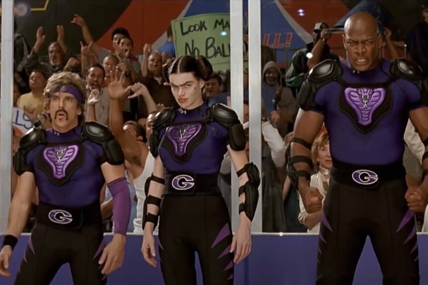 White Goodman(Ben Stiller), Fran (Missi Pyle), and Me'Shell Jones (Jamal Duff) stand in their dodgeball uniforms in Dodgeball: A True Underdog Story (2004).