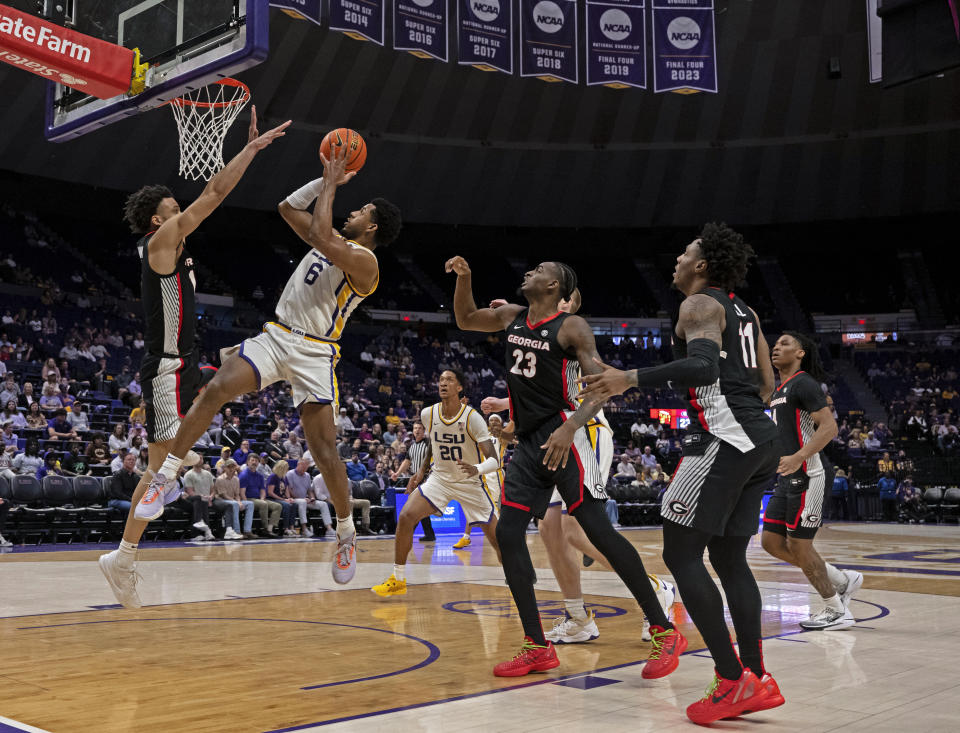 LSU guard Jordan Wright (6) goes up against Georgia guard Jabri Abdur-Rahim, left, under the basket during an NCAA college basketball game Tuesday, Feb. 27, 2024, inBaton Rouge, La. (Hilary Scheinuk/The Advocate via AP)