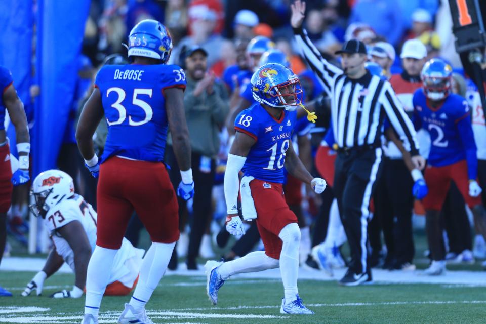 Kansas redshirt junior center back Kalon Gervin (18) stop an Oklahoma State first down in the third quarter of Saturday's game at David Booth Kansas Memorial Stadium.