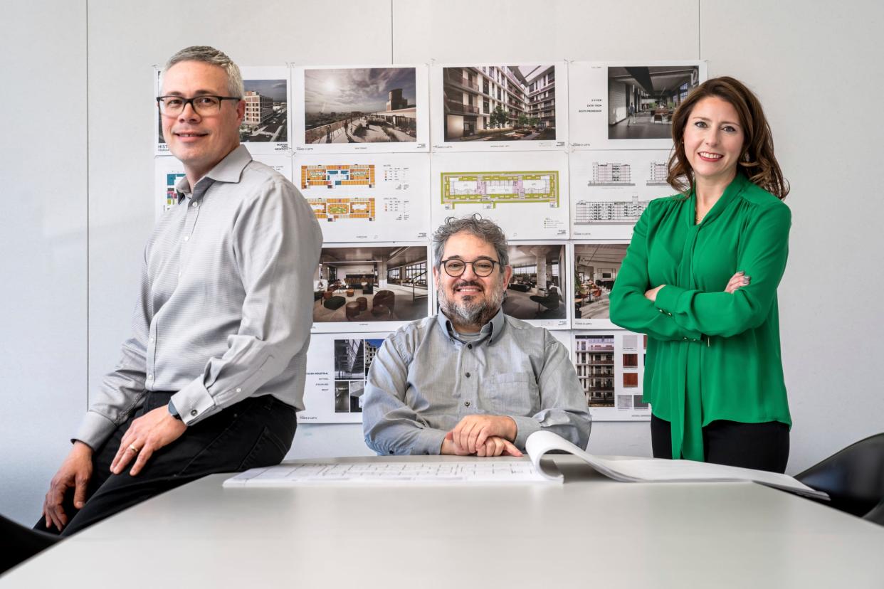 (Left to right) McIntosh Poris Architects principal John Skok, founding principal Michael Poris and principal Laurie Hughet-Hiller pose for a photo in a meeting room for their business in Birmingham on Monday, March 11, 2024.