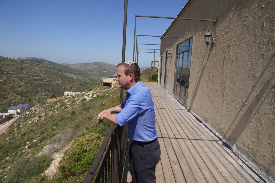 Yotam Eyal, a lawyer, looks out over the hillside view from Givat Hirel, an Israeli settlement in the West Bank on April 18, 2023.